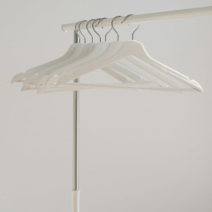 white clothes hangers hanging on rack