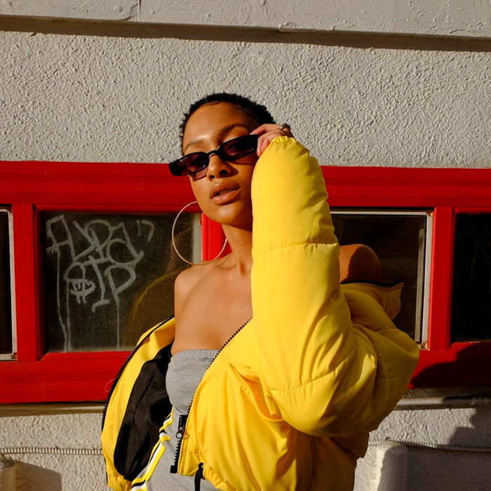 woman holding her sunglasses