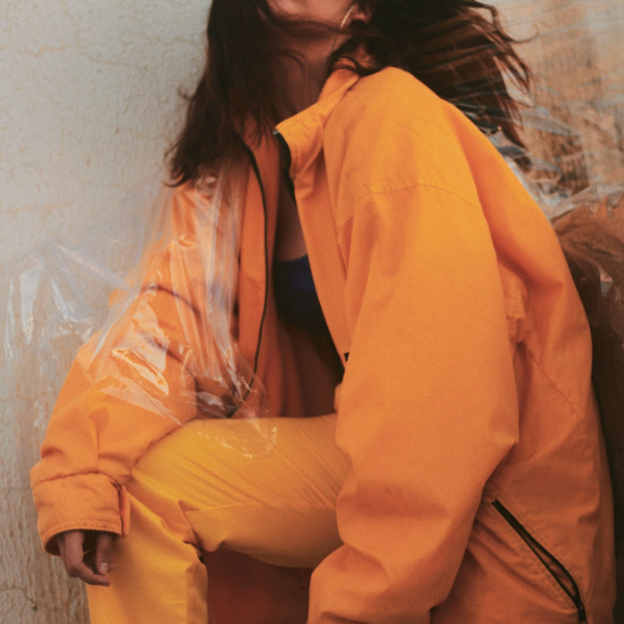 woman leaning beside wall