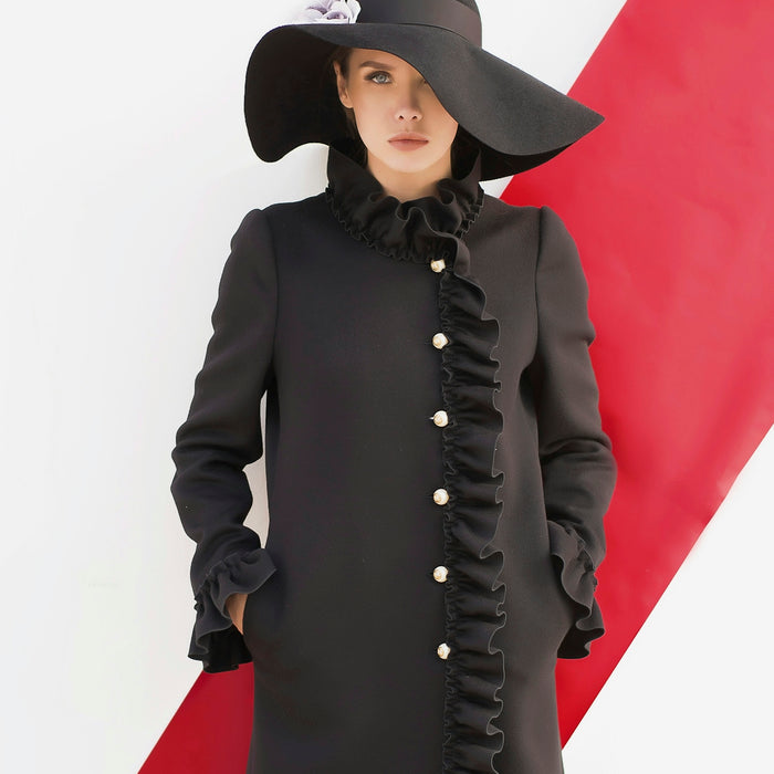 woman wearing black long-sleeved dress and black sunhat