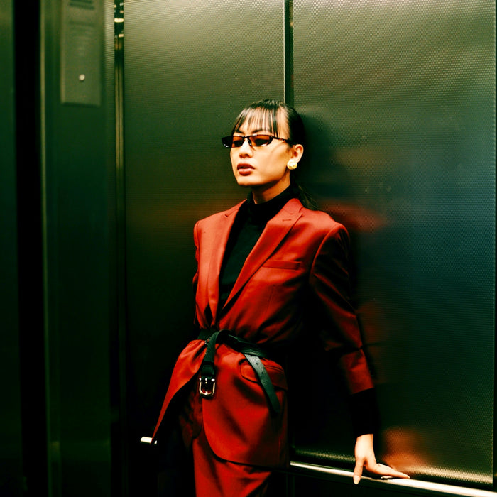 woman in red blazer in elevator