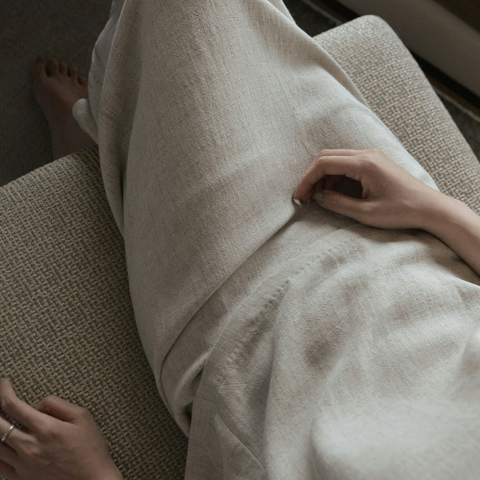 woman wearing white dress sitting sofa chair