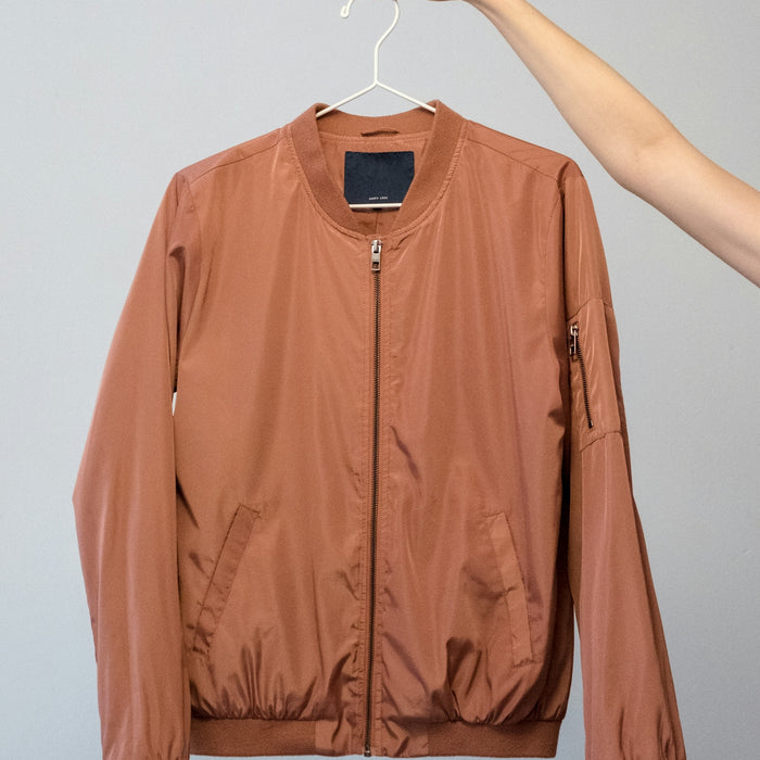 brown long sleeve shirt on white clothes hanger
