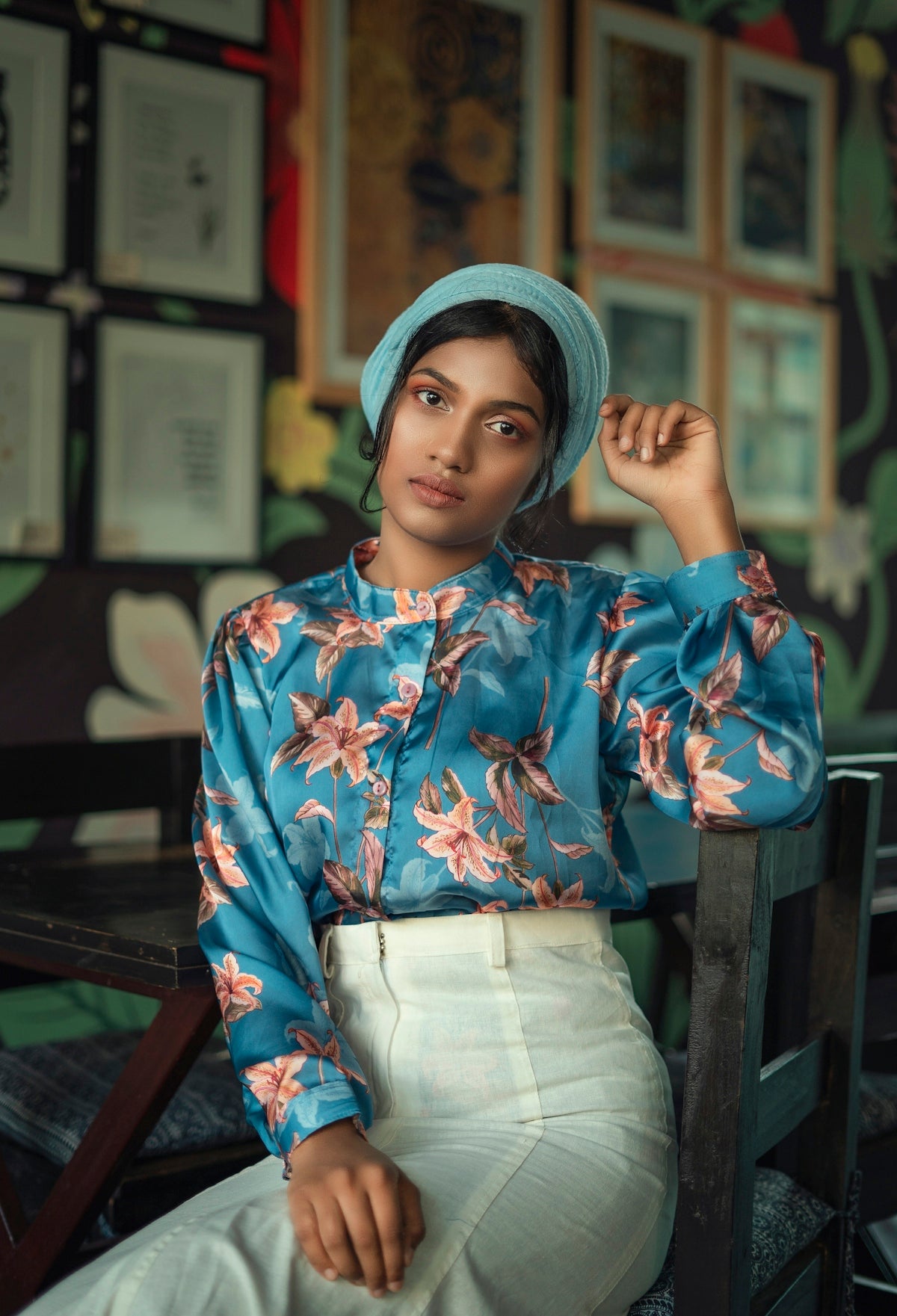 woman in blue and red floral long sleeve shirt and blue knit cap