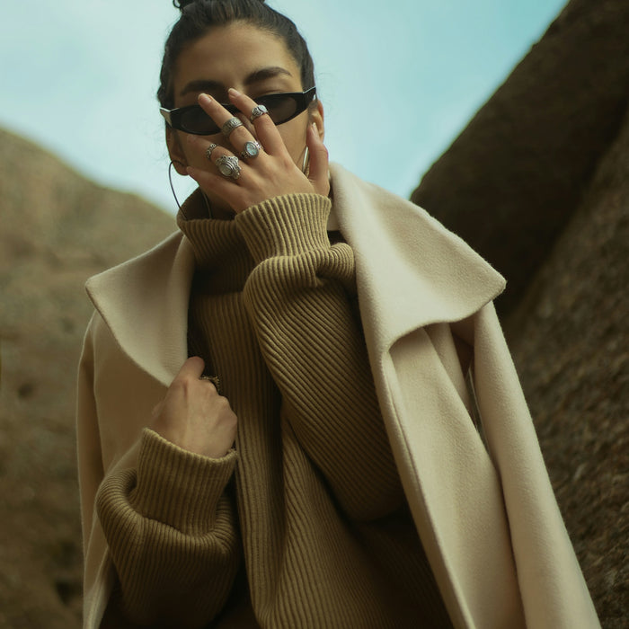 man in brown coat wearing black sunglasses