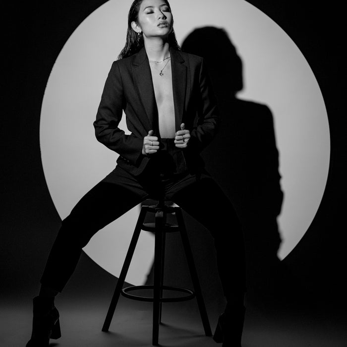 woman in black suit jacket sitting on seat