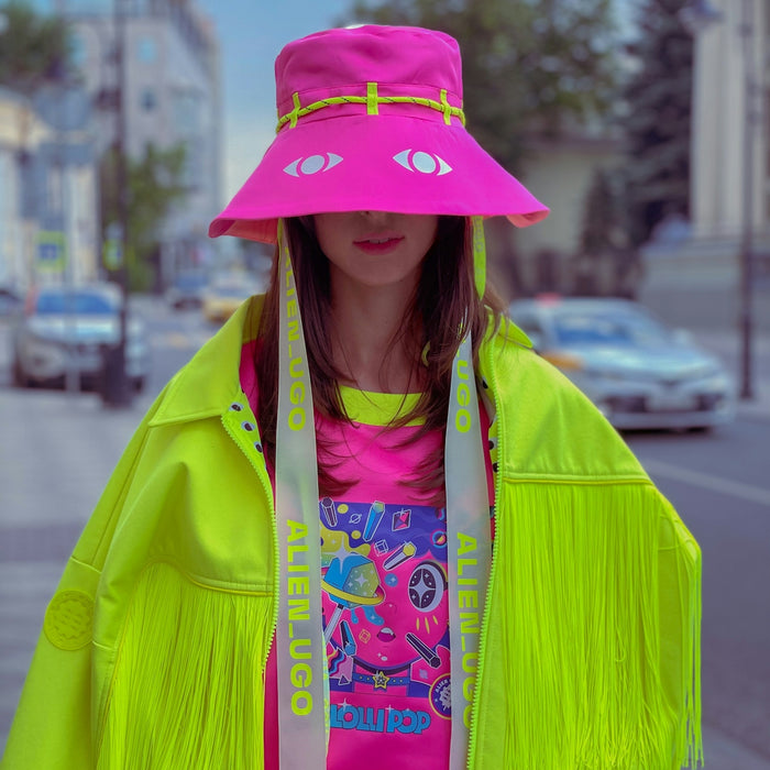 woman in green jacket wearing pink hat