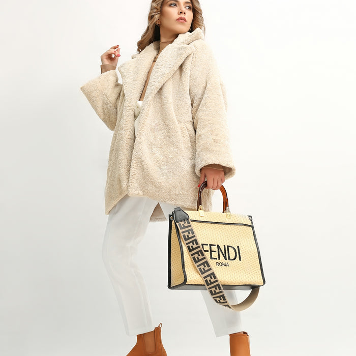 a woman in a fur coat holding a fendi bag
