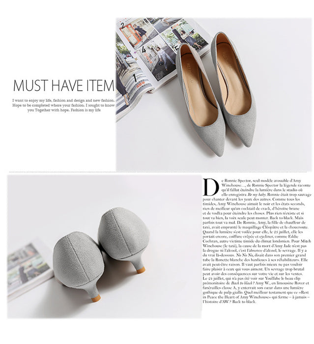 Gray pointed-toe shoes on a white surface with a magazine in the background.