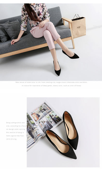 Woman sitting on a couch wearing black pointed-toe shoes with a magazine and shoes displayed below.