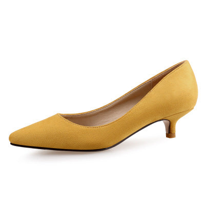 Yellow high-heeled shoe on a white background