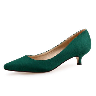 Green high-heeled shoe on a white background