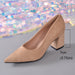 A beige pointed-toe pump with a chunky block heel, shown on a gray surface with a background of iridescent sequins. A measurement overlay indicates the heel height is 7cm (2.