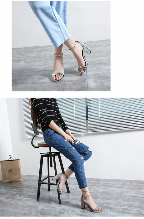 Person sitting on a stool wearing blue jeans and high-heeled shoes in an indoor setting.