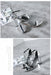 Silver high-heeled shoes on a gray concrete floor with a magazine.