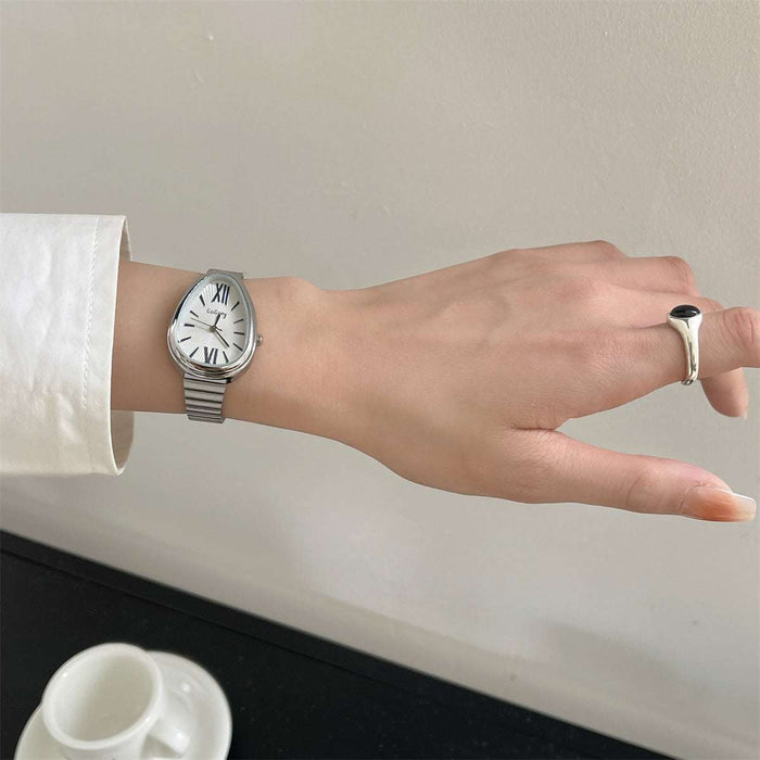 Hand wearing a silver watch with a plain background