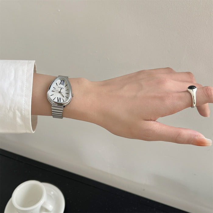 Hand wearing a silver watch with a plain background
