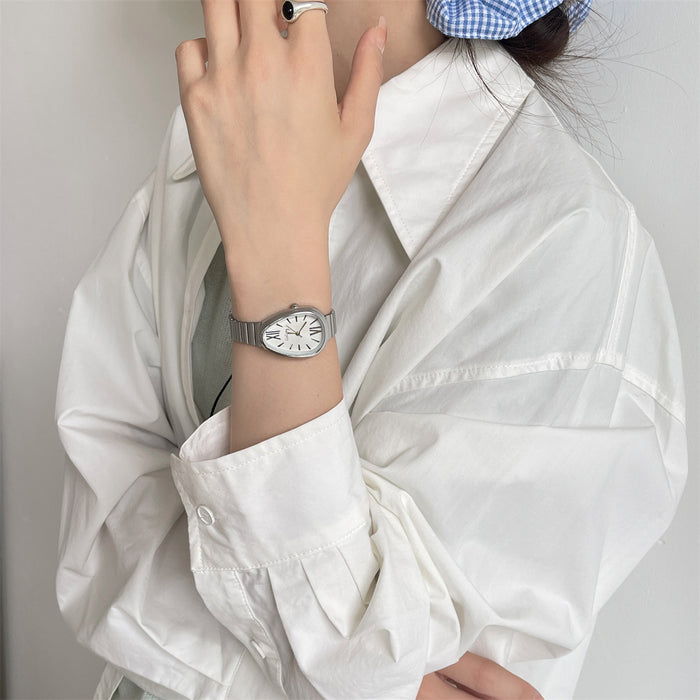 Hand wearing a gold watch with a white background