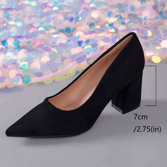 A single black pointed-toe high heel shoe shown on a gray surface with a colorful sequin backdrop. A measurement overlay indicates the heel height as 7cm (2.