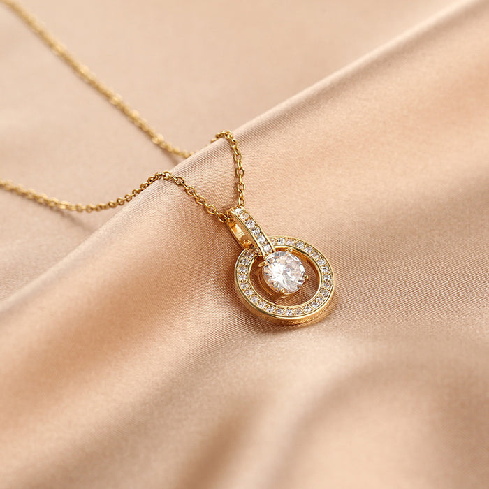 Gold necklace with a diamond pendant on a beige fabric background