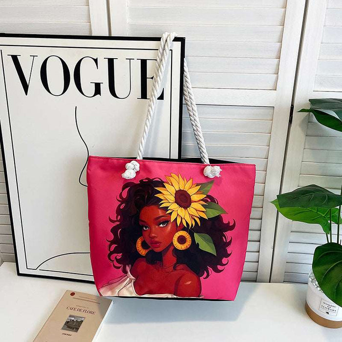 Tote bag with a design of a woman with flowers in her hair on a pink background, placed on a surface with a 'Vogue' magazine in the background.
