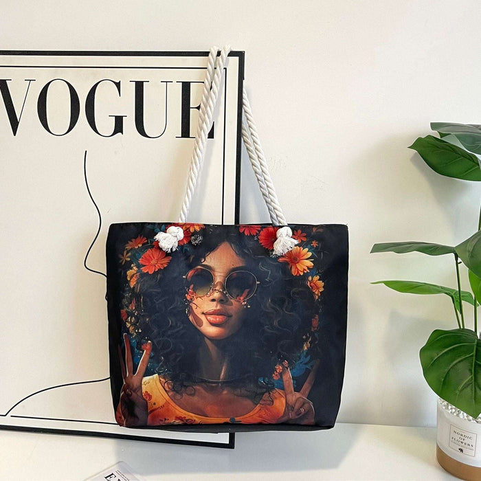 Tote bag with a design of a woman with flowers, placed on a surface next to a 'Vogue' magazine.