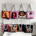 Set of tote bags with artistic depictions of women hanging on a rack.