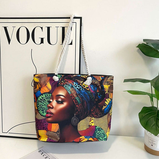 Colorful tote bag with a design of a woman wearing a headscarf on a white surface with a 'Vogue' magazine.