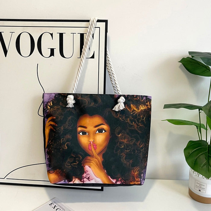 Tote bag with a design of a woman's face on a surface with a 'Vogue' magazine in the background.