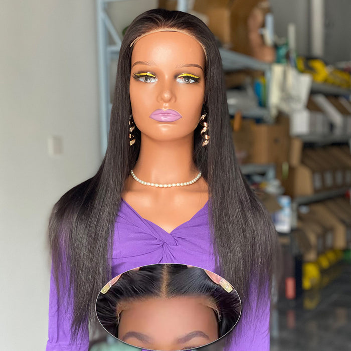 Mannequin head with long black hair and purple top in a store setting