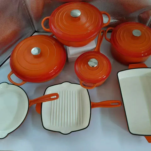 Set of orange cookware with white interiors on a white background