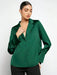 Woman wearing a green blouse against a white background