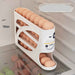 White egg holder with eggs inside, showing dimensions, in a kitchen setting.