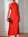 Red dress with a black clutch against a neutral background