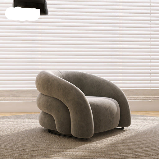 Modern gray armchair in a room with light-colored blinds and carpet.