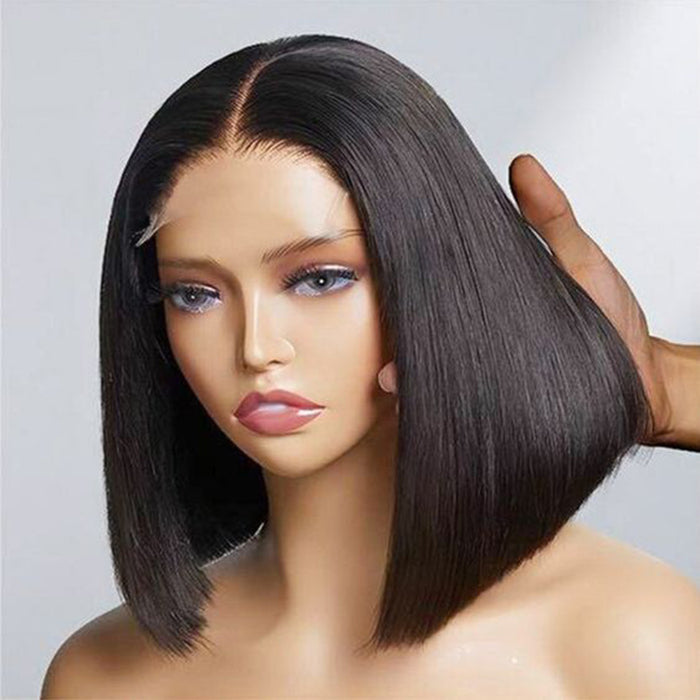 Mannequin head with a black bob wig on a plain background