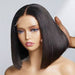 Mannequin head with a black bob wig on a plain background