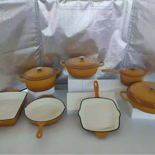 Set of yellow cookware with white interiors on a white background