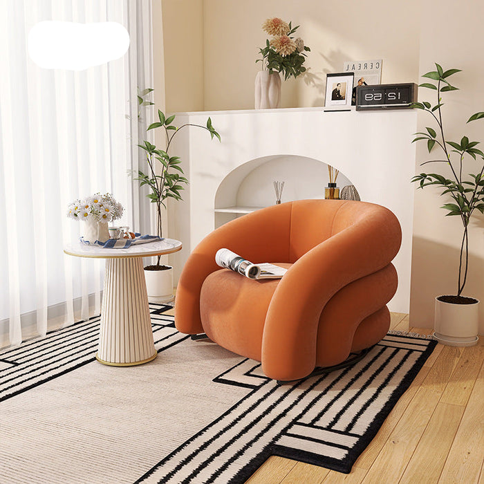 Orange armchair in a modern living room with decor elements.