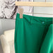 Green pants on a hanger against a neutral background