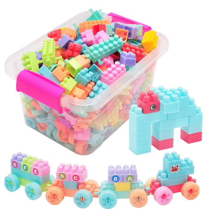 A clear plastic storage bin filled with colorful children's building blocks, with two example constructions shown outside the bin: a light blue and pink elephant and a small multicolor train. The background is plain white.