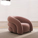 Pink armchair in a room with light-colored blinds