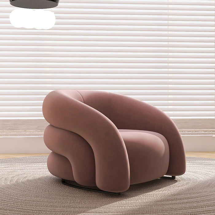 Pink armchair in a room with light-colored blinds