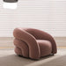 Pink armchair in a room with light-colored blinds