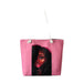Pink tote bag with a graphic of a woman's face on a white background