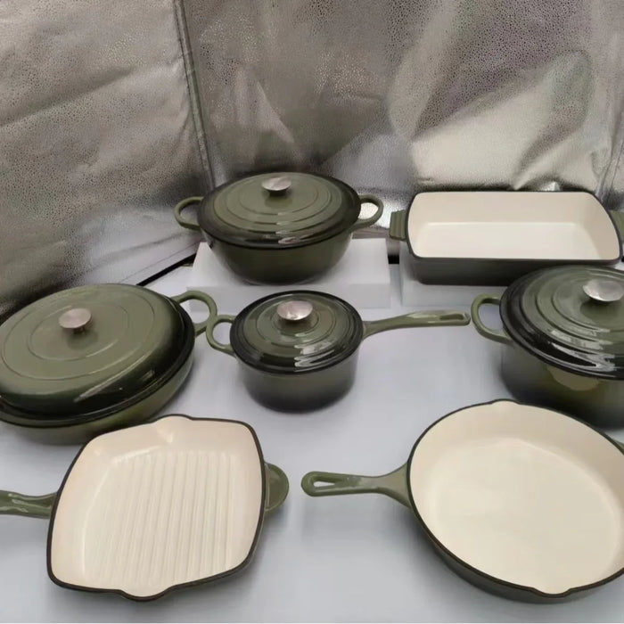 Set of green cookware with beige interiors on a light gray background