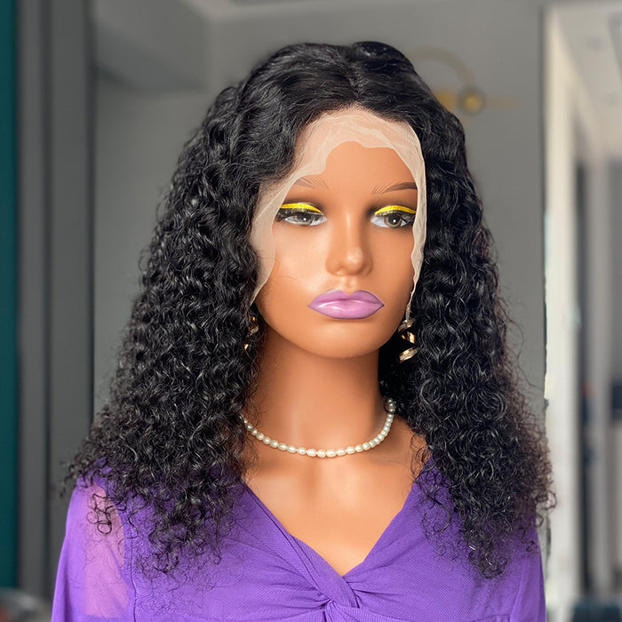Mannequin head with a black curly wig and purple top, wearing yellow makeup.
