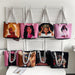 Set of tote bags with artistic depictions of women hanging on a rack.