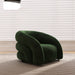 Green armchair in a room with light-colored blinds and carpet.