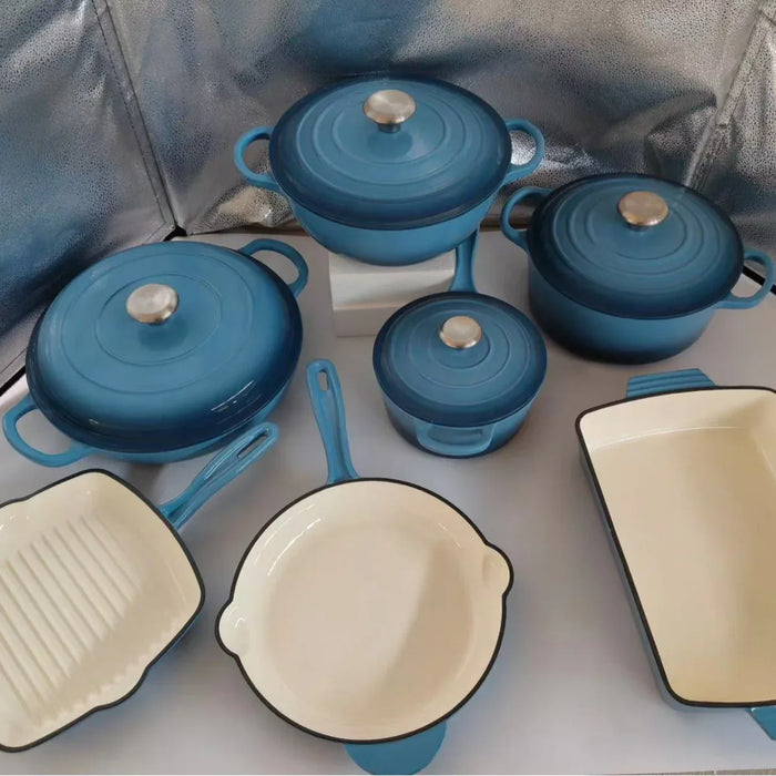 Set of blue and beige cookware on a reflective surface